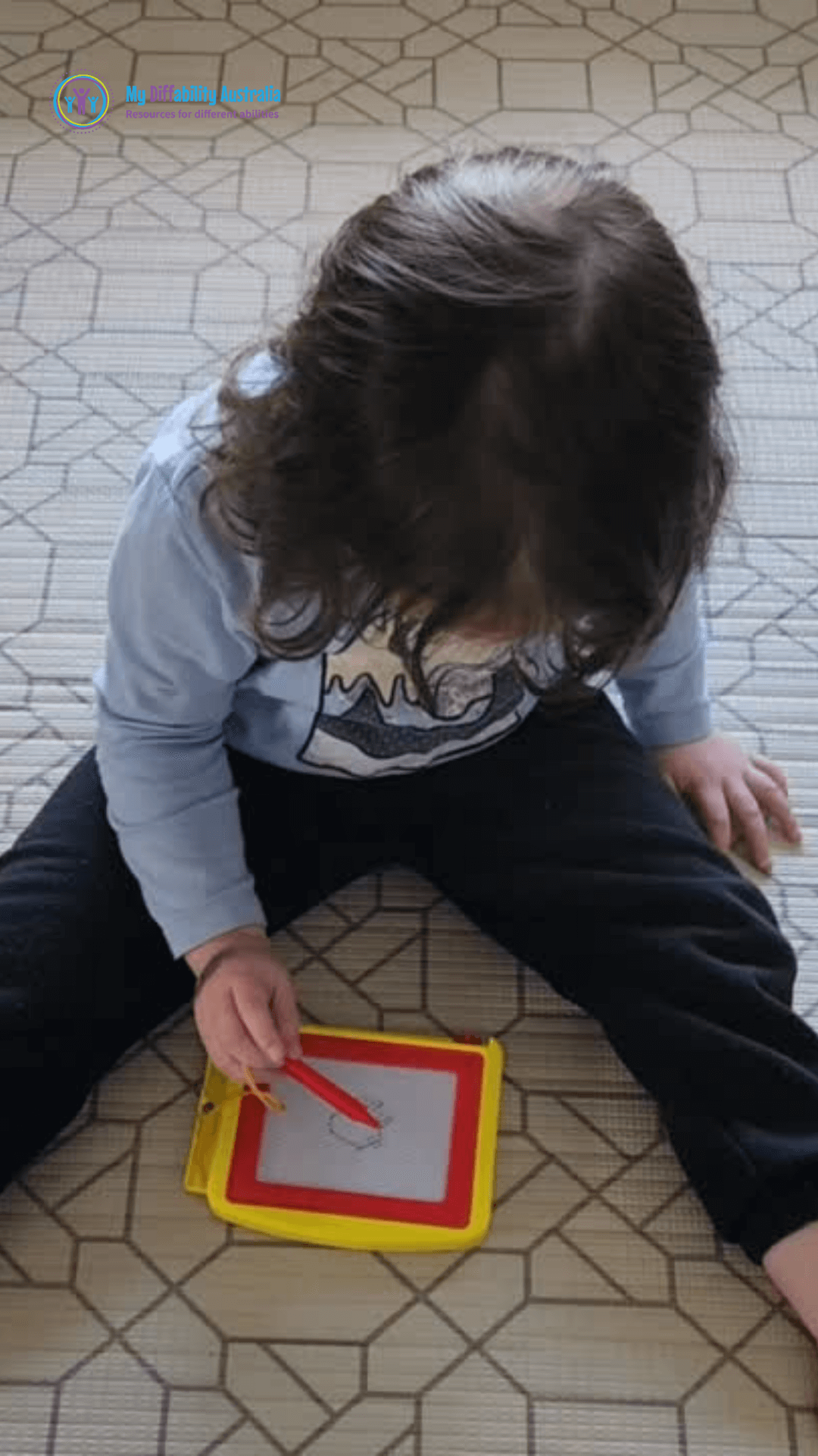 Kid Using Magnetic Drawing Board