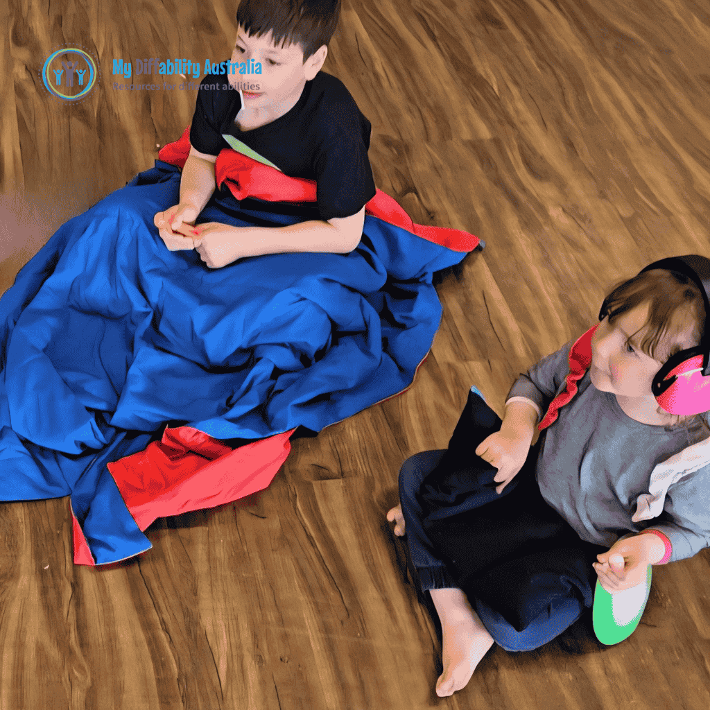 2 children seating side by side while weighted blankets are on their lap
