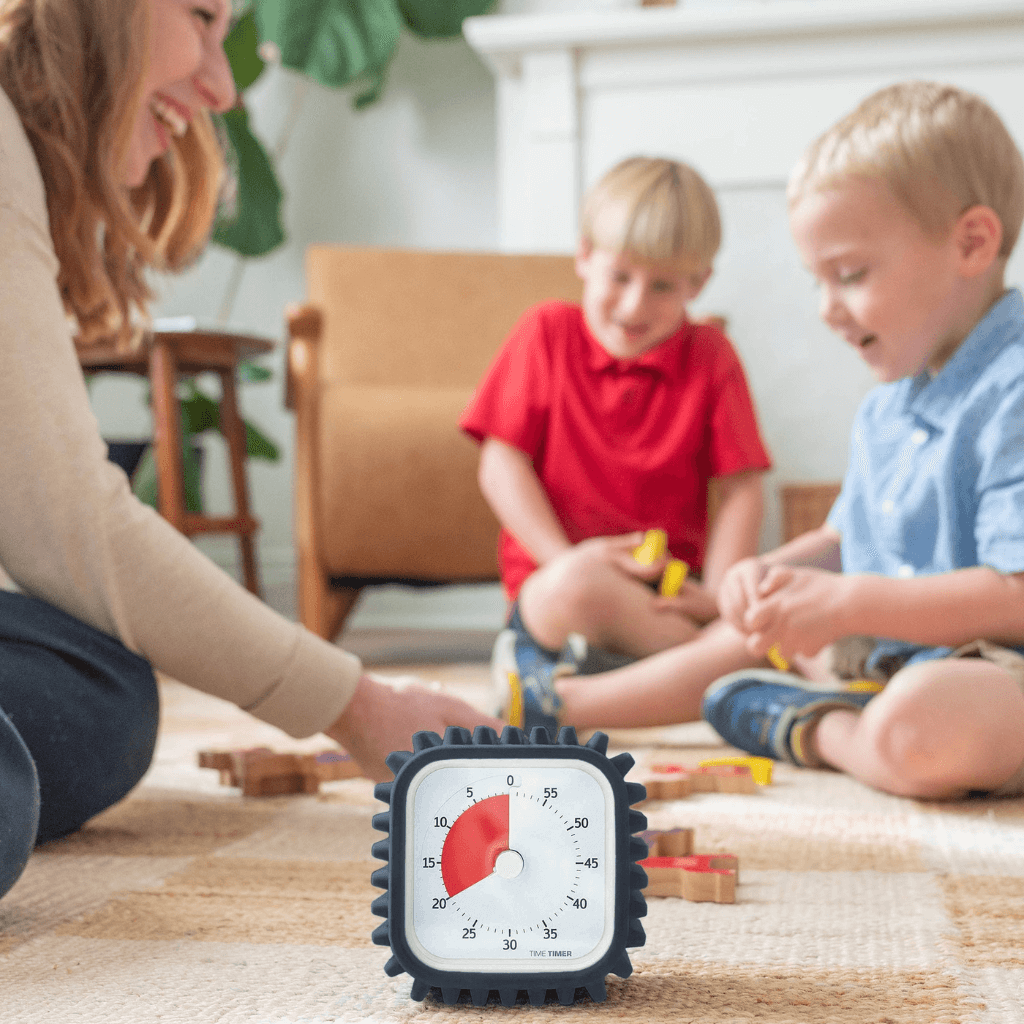 2 kids playing with time timer mod with case on the side