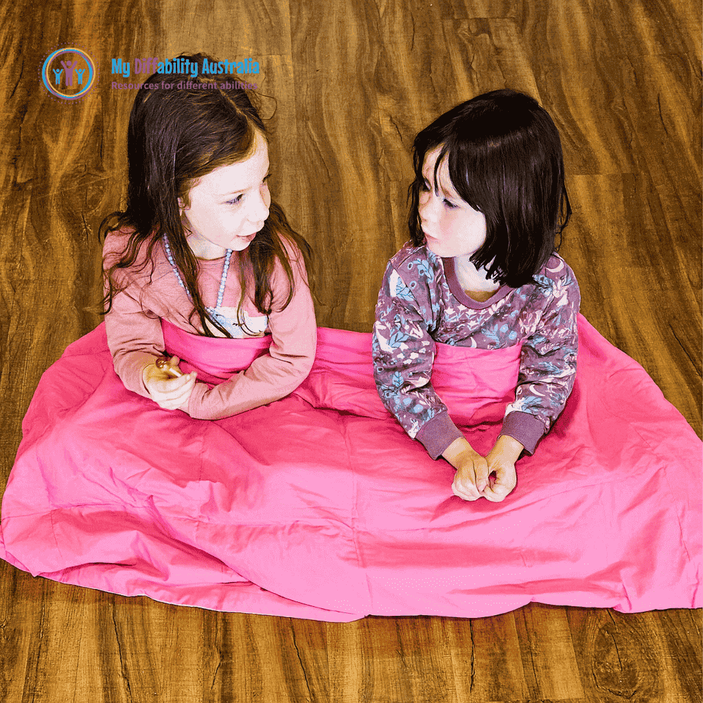 2 young girls chatting while they covered with Weighted Blanket Single bed size pink on pink