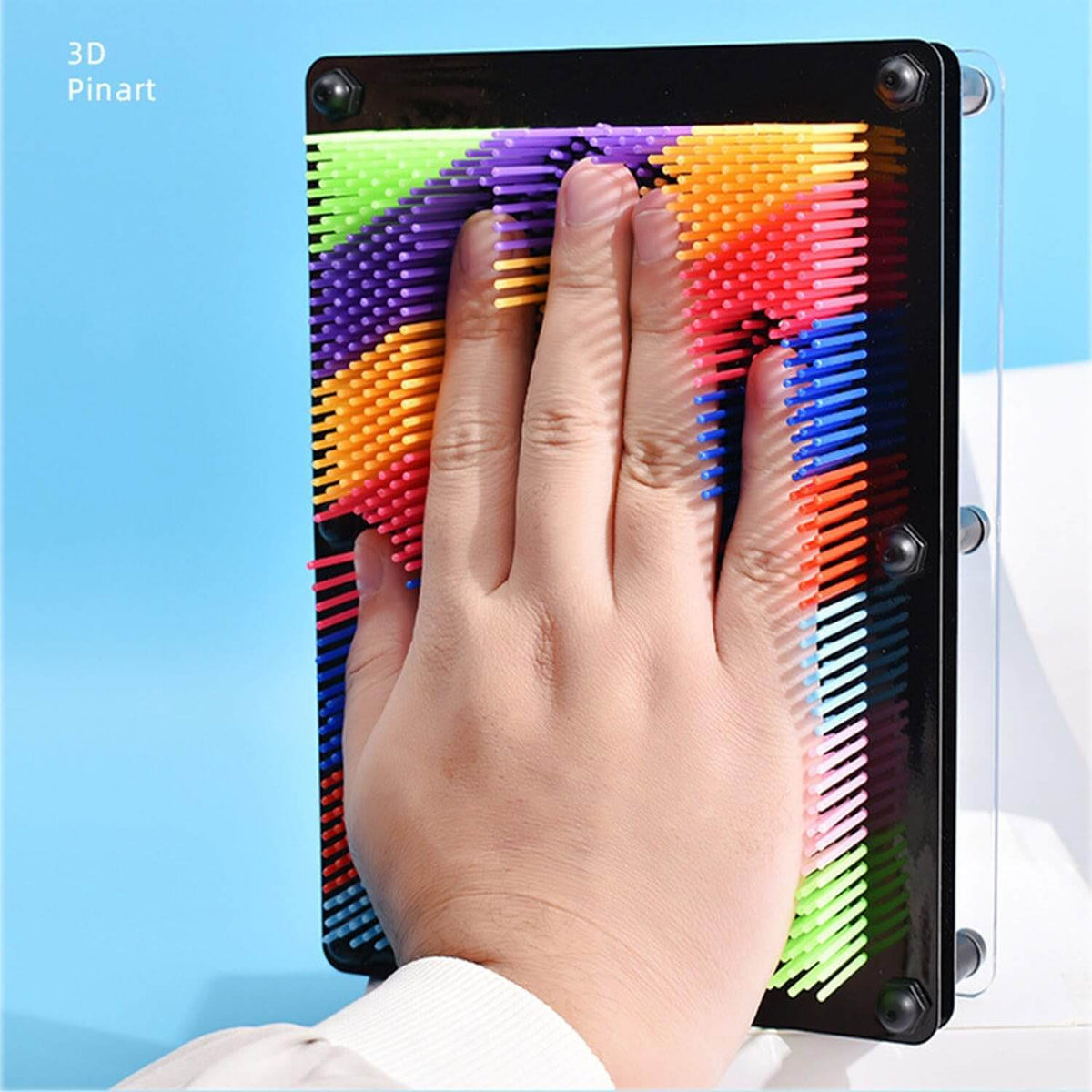 3d pin art rainbow where a hand is pressing it