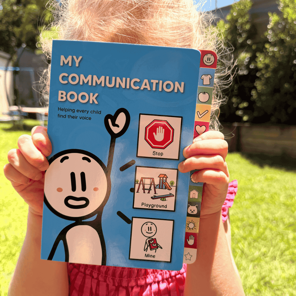 A Young Girl Holding the new version of My Communication Book