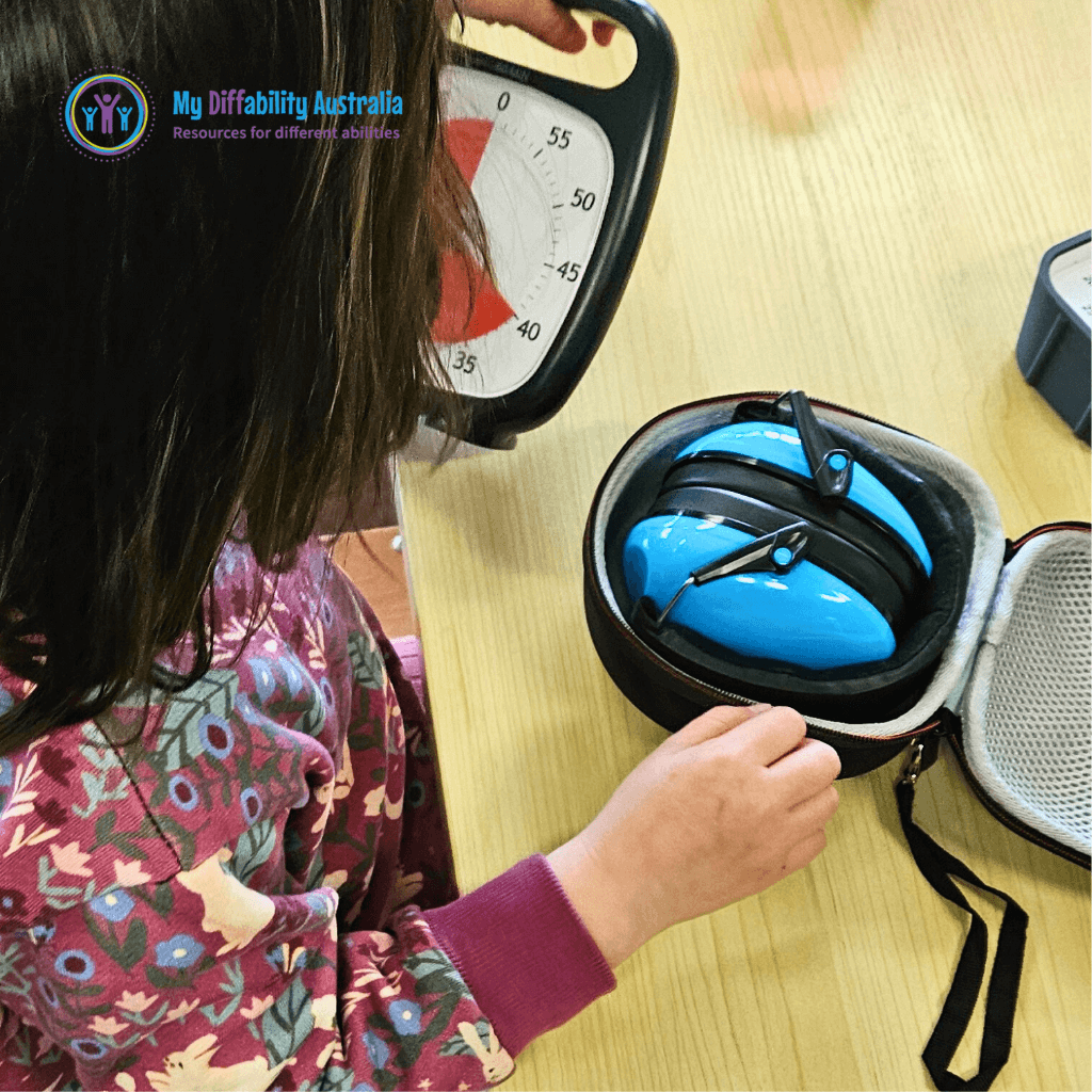 Student with blue ear defenders inside hard carry case