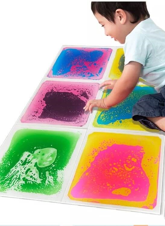 Boy Seating Down In The Sensory Liquid Tile