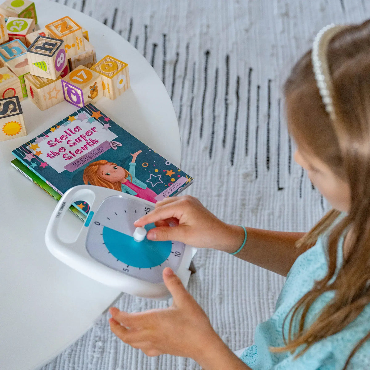 Girl Holding Time Timer Plus 20 with her books