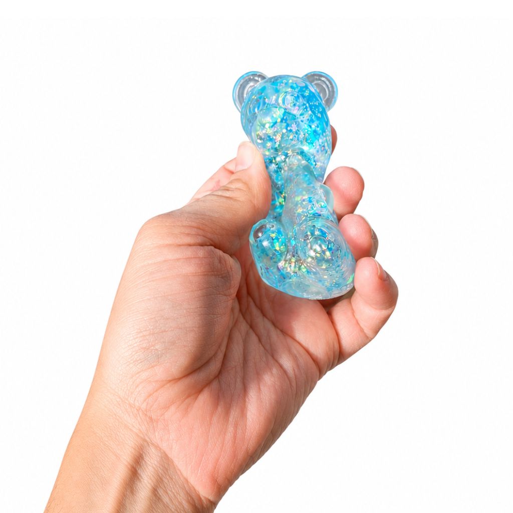 Hand Squishing the Blue Glitter Gummy Bear