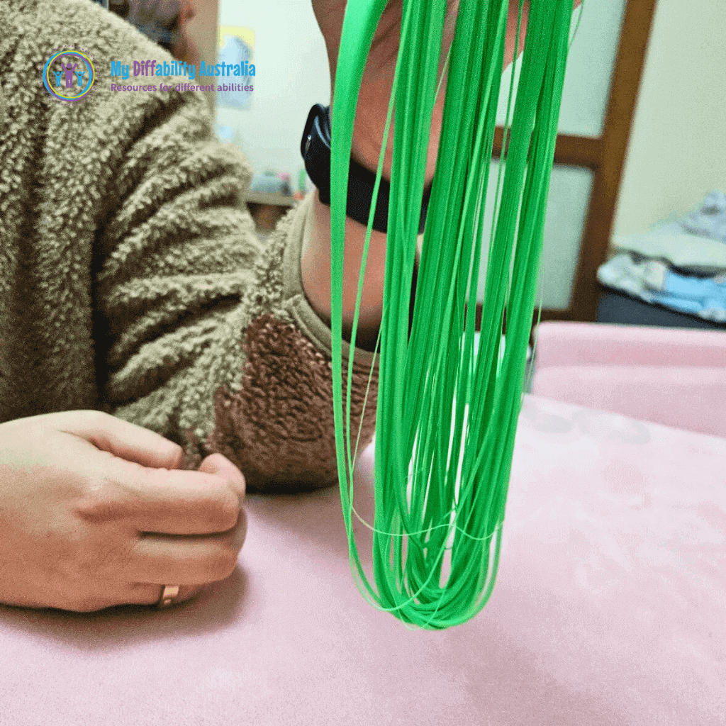 Holding the Green Spaghetti Putty By One Hand