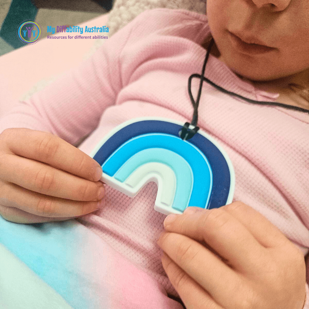 Kid Holding Rainbow Chewy Pendant