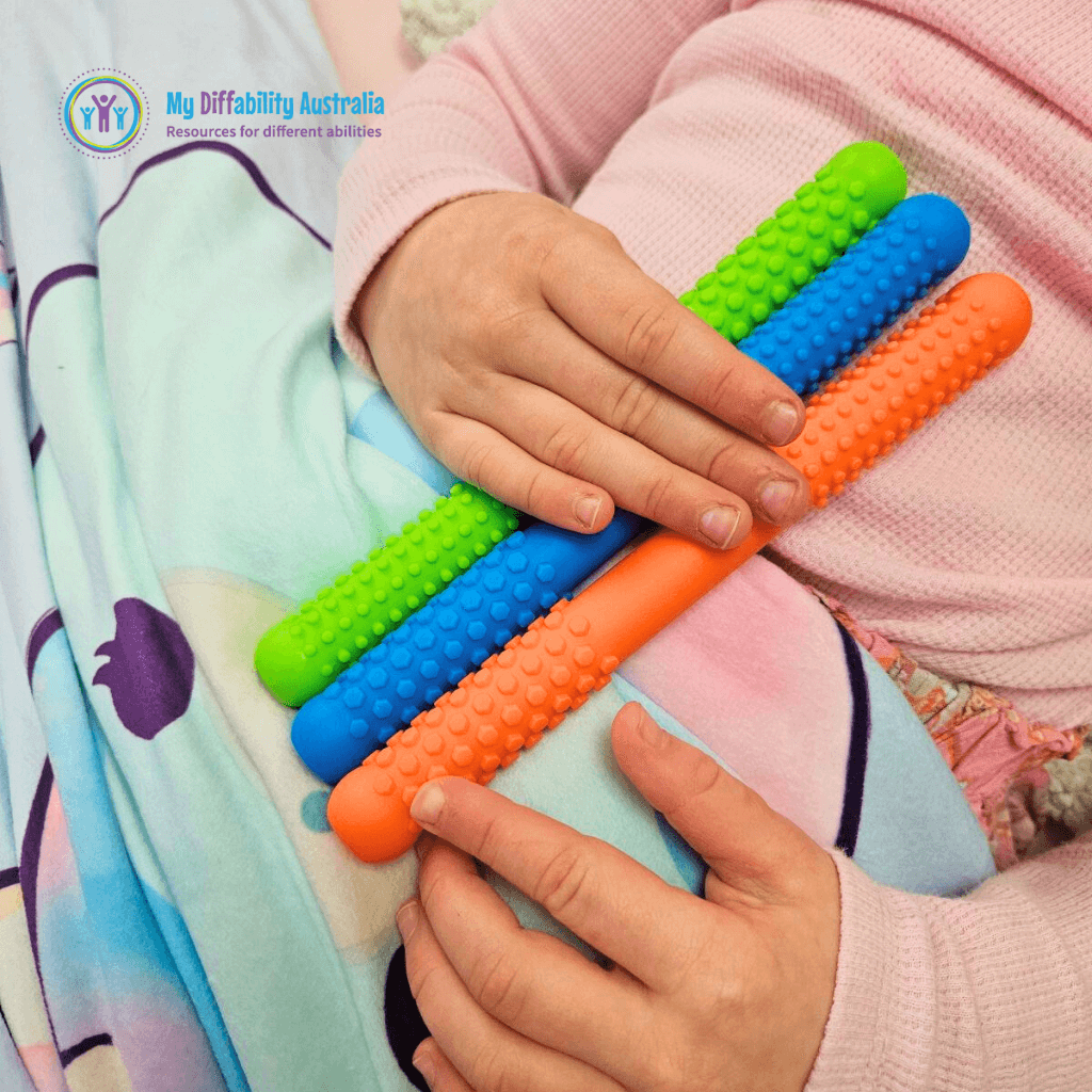 Kid Holding Textured Hollow Bite Tubes Set of 3 orange blue green tubes