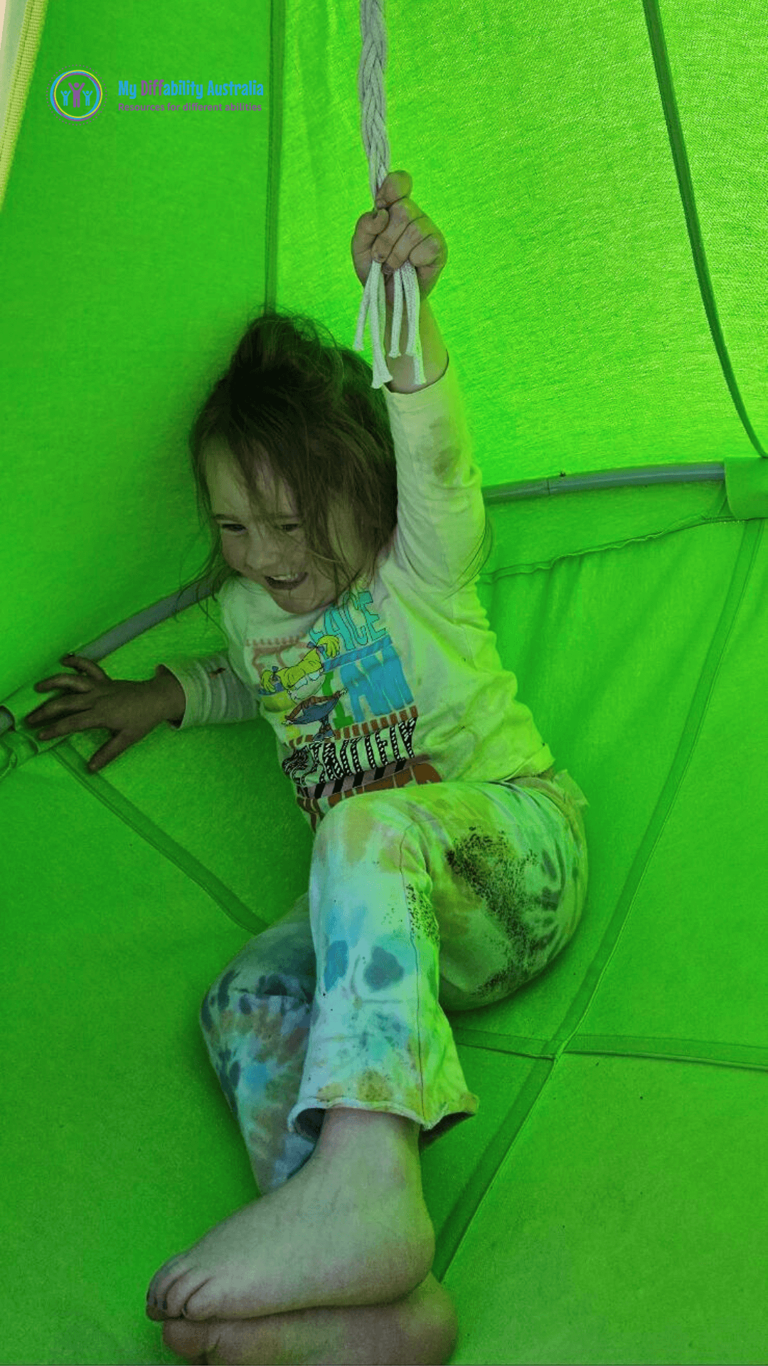kid inside the pod swing holding the rope