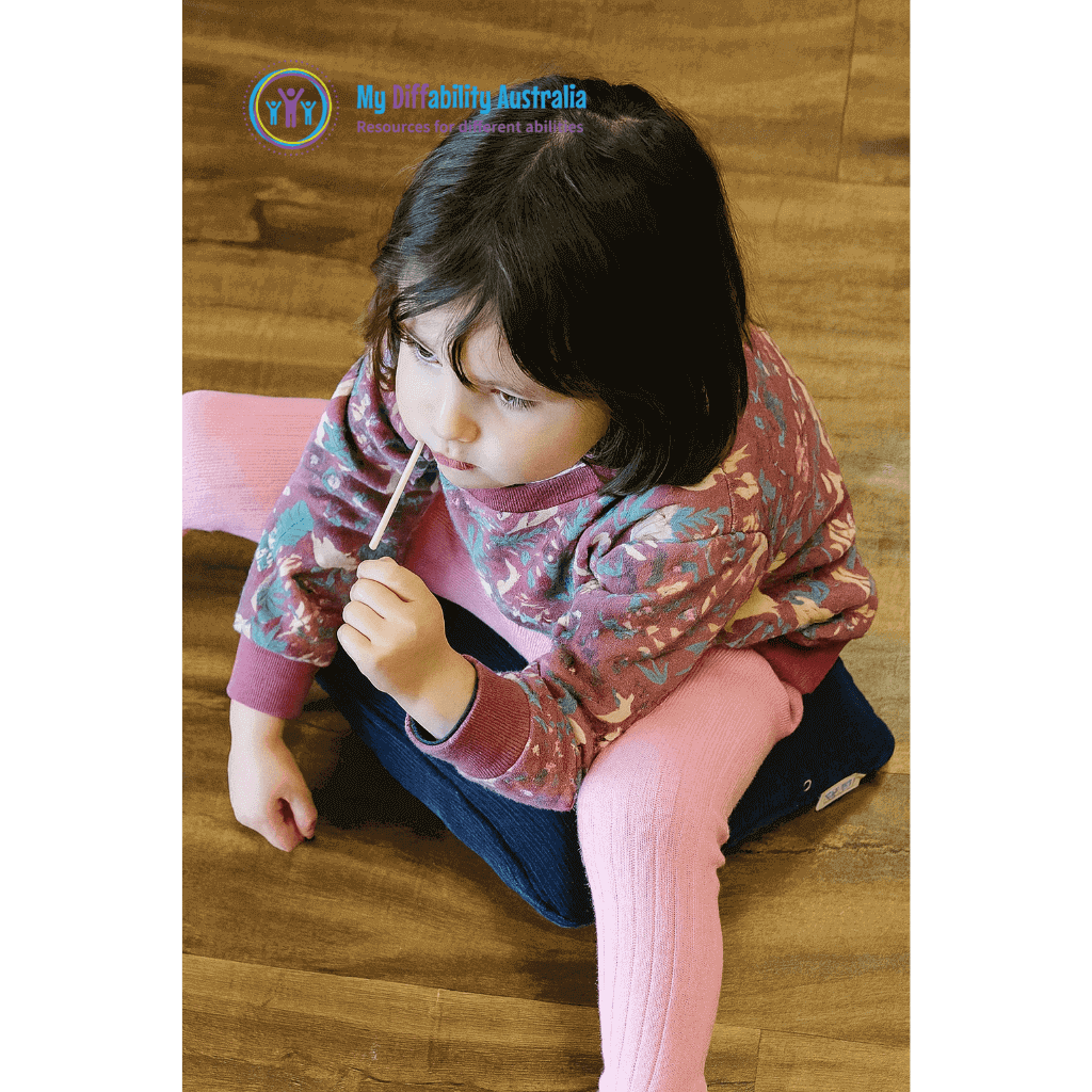 Kid Seating in Pressure Activated Vibrating Cushion while in the floor