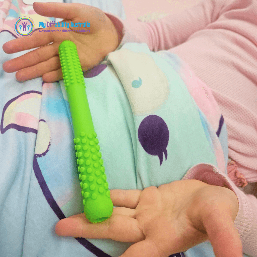 Kid Showing the size of Textured Hollow Bite Tubes