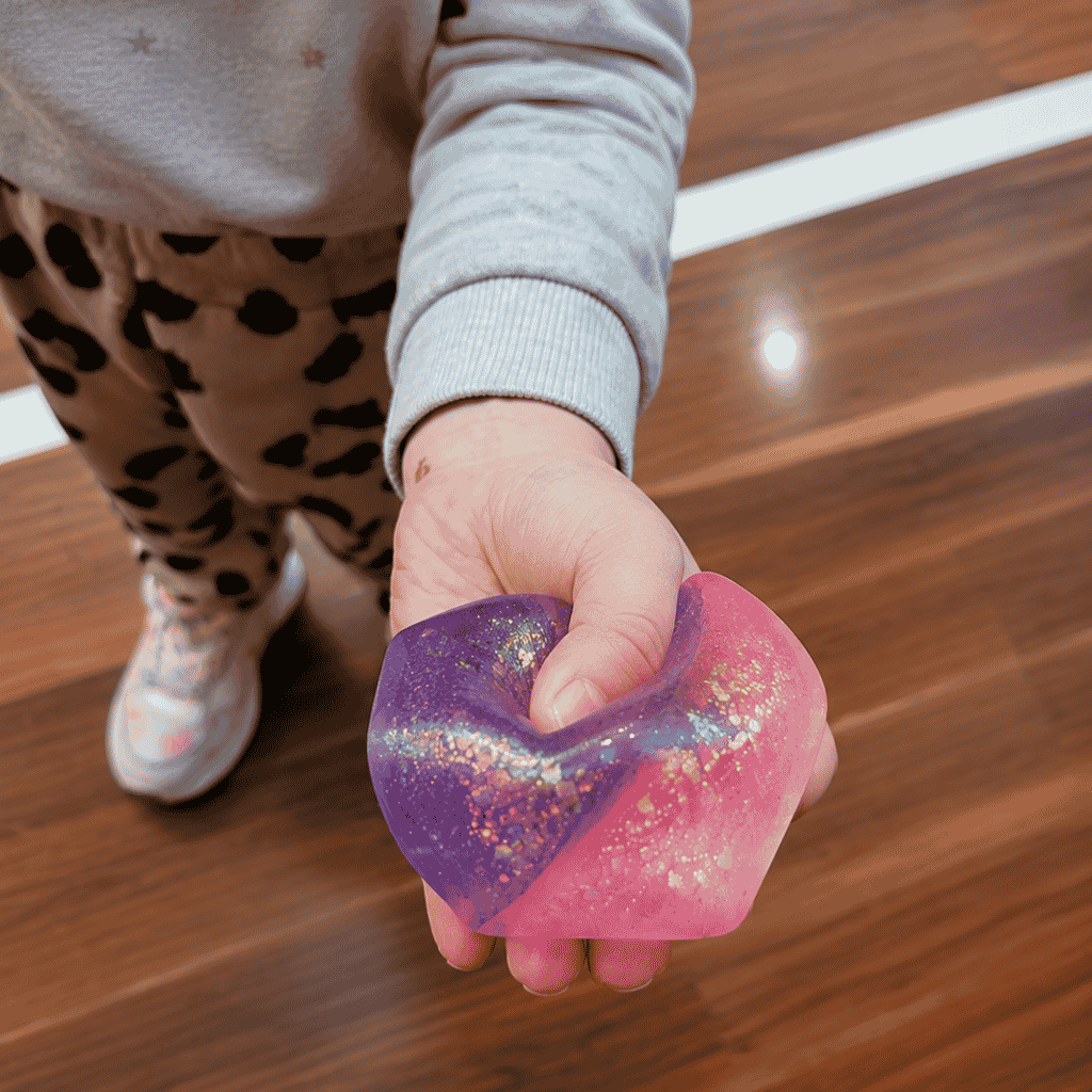 Kid Slightly Squeezing Two Tone Glitter Squeezy Cube