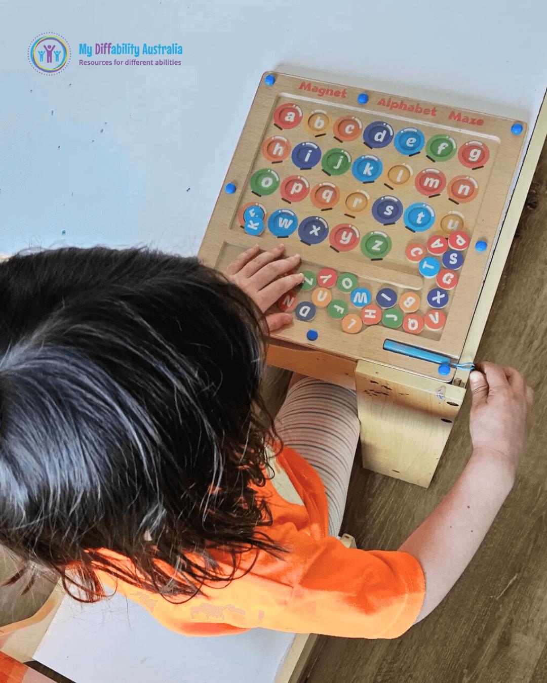 Kid Trying Magnetic Alphabet Maze Game