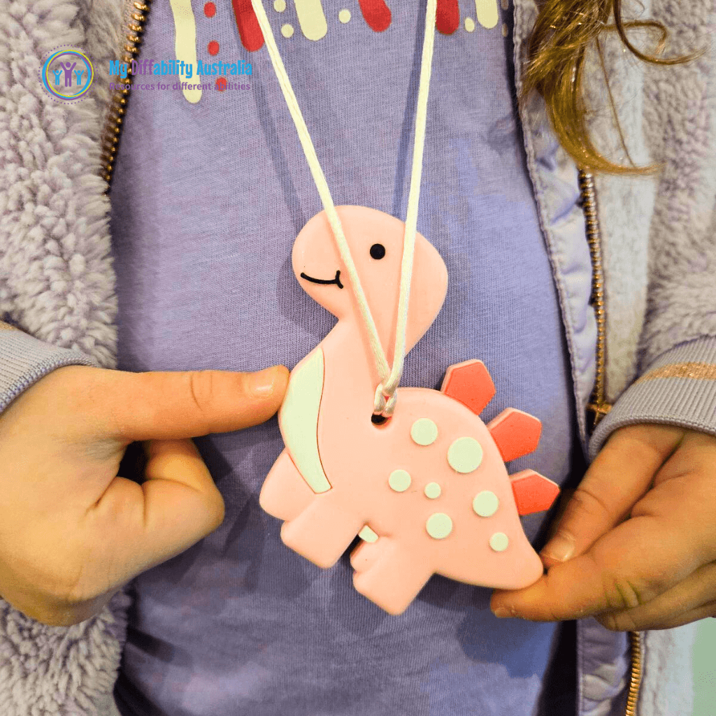 Kid Wearing Pink Dinosaur Chewy Pendant Zoom In