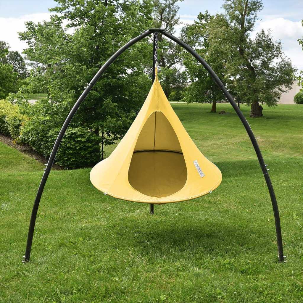 Lifestyle Image of Single Cacoon Lemonade Assembled in Tripod Hanging Chair stand