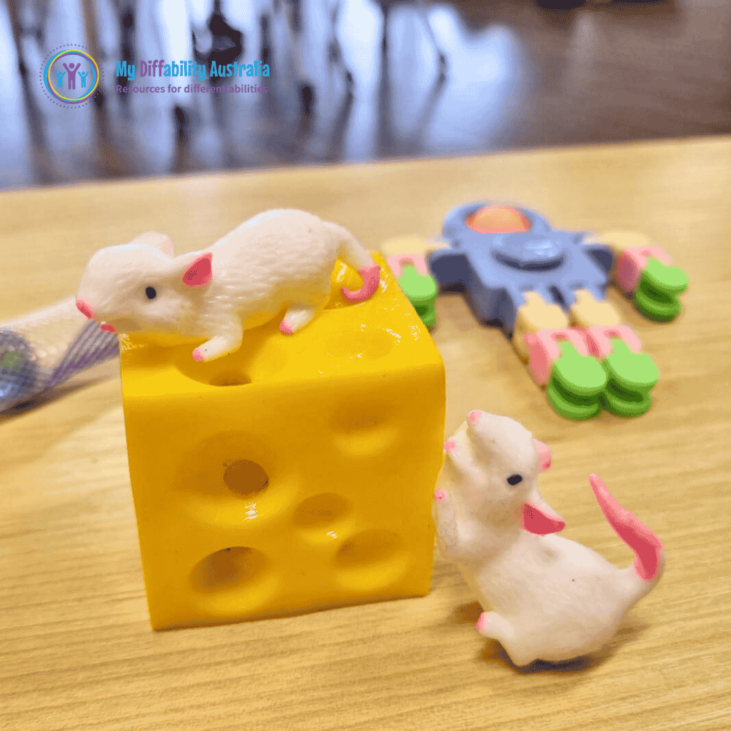 Lifestyle Photo of Squeezy Mouse And Cheese Fidget placed on top a table