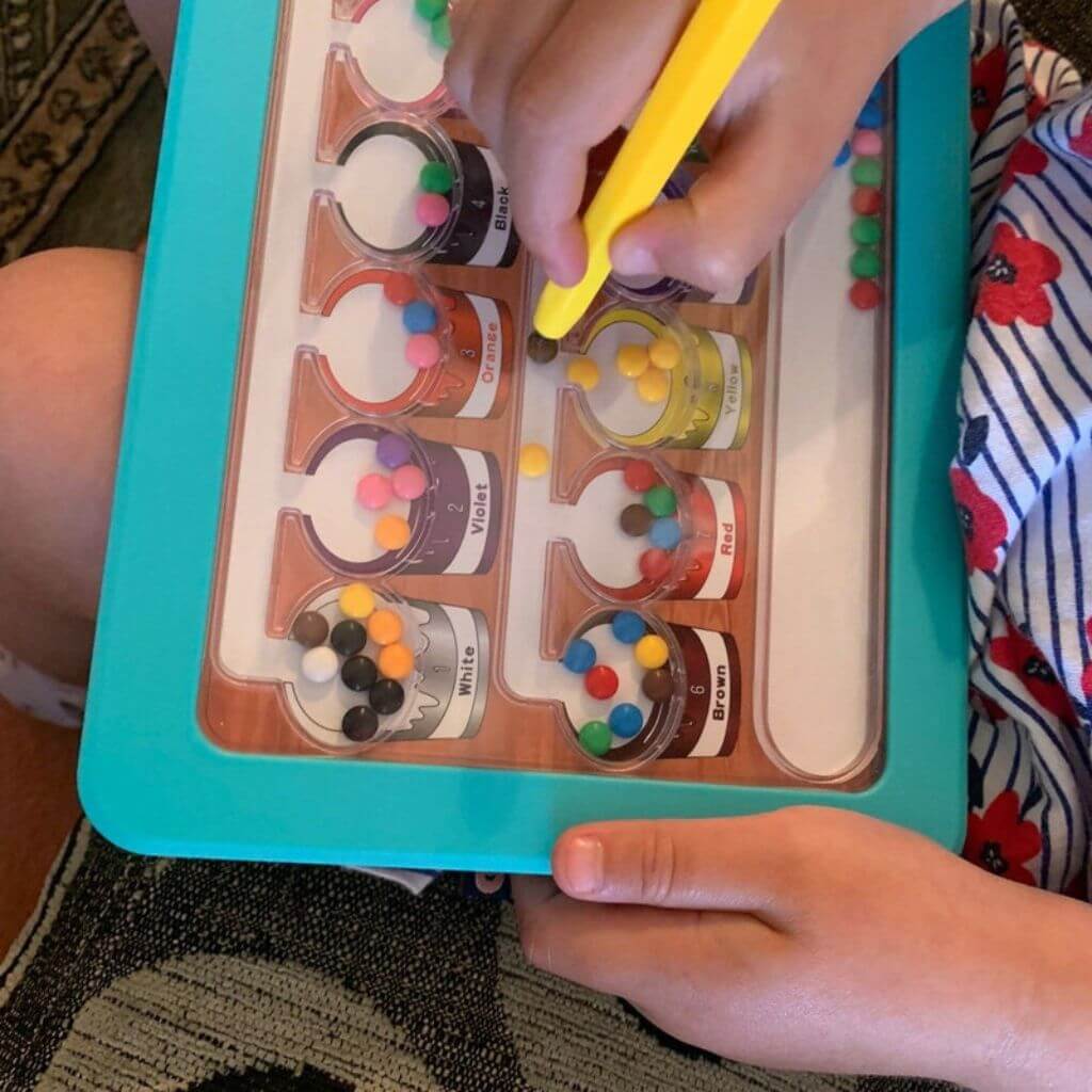 Pictue of Colour Number Maze Magnetic Pad in a kids lap
