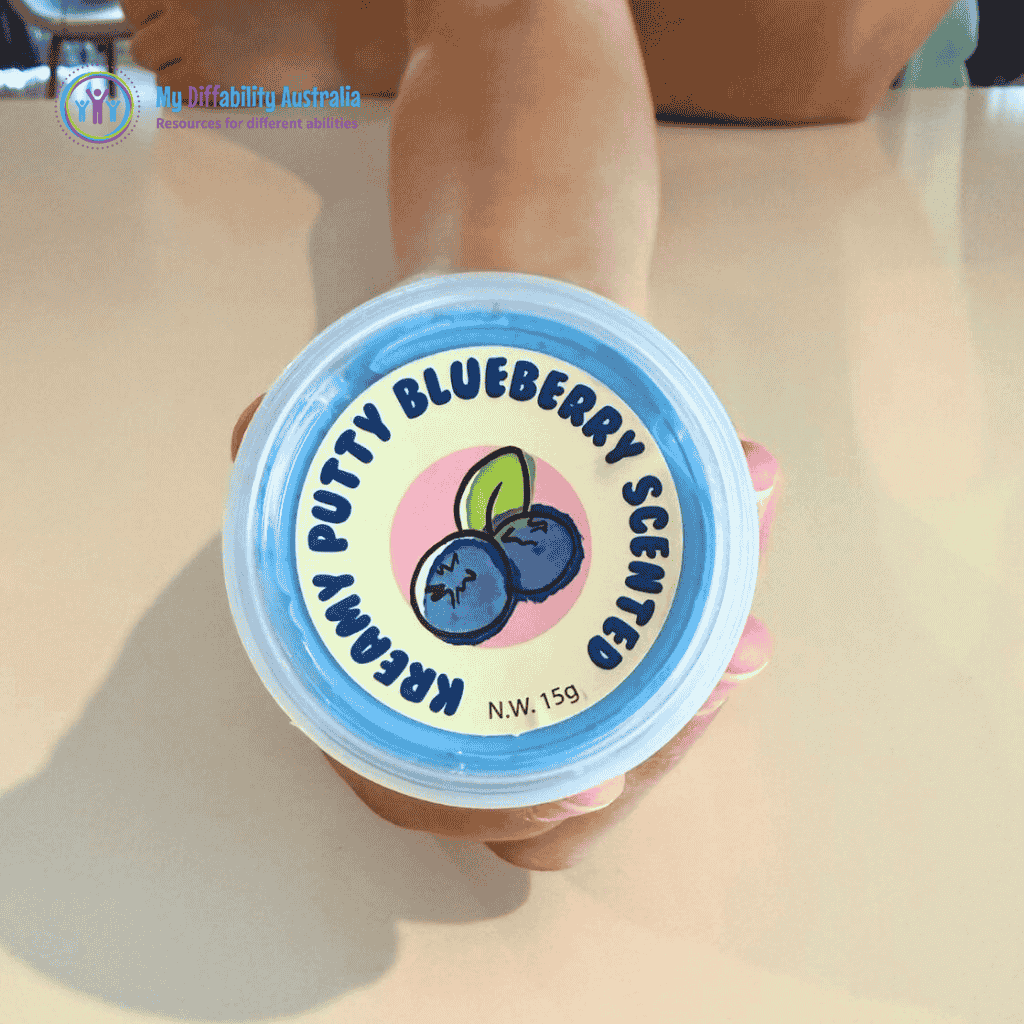 Picture of a hand holding the packaging of Scented Kreamy Putty