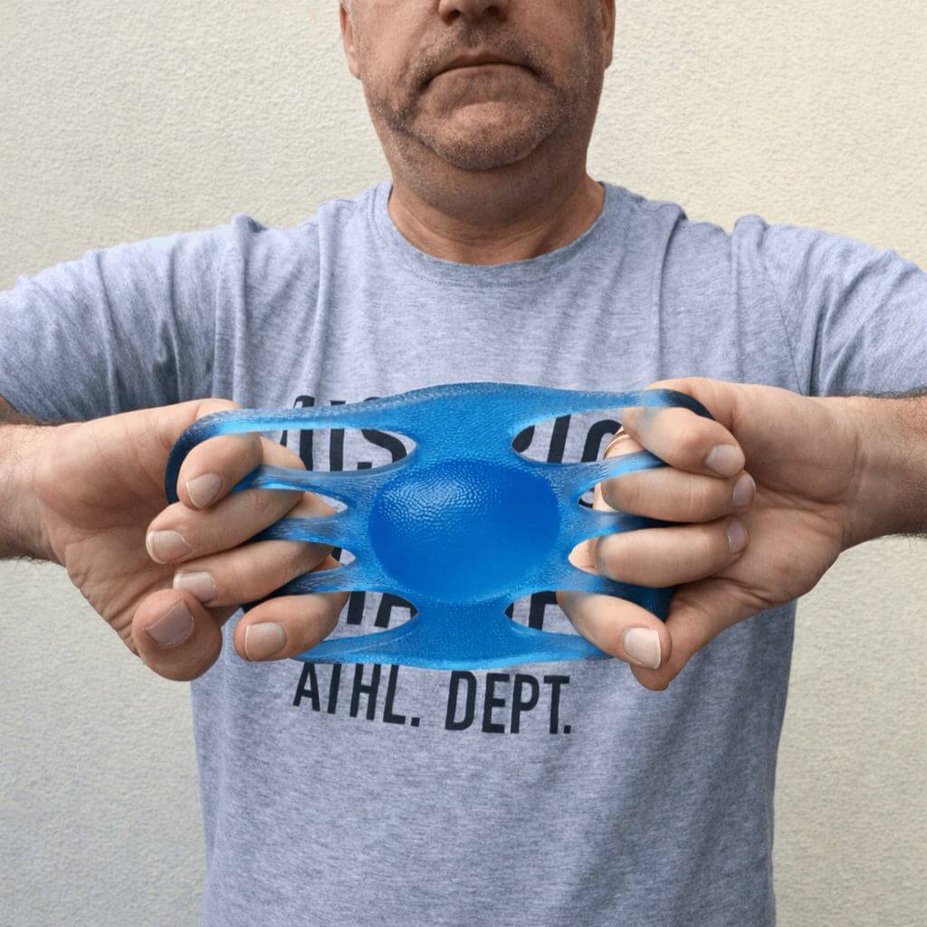 Picture of a man stretching Out of This World Grip Emotional Regulation Strengthening tool