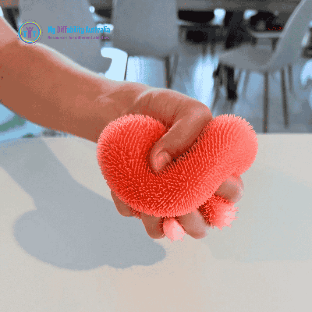 Picture of a squeezing NeeDoh Fuzz Ball