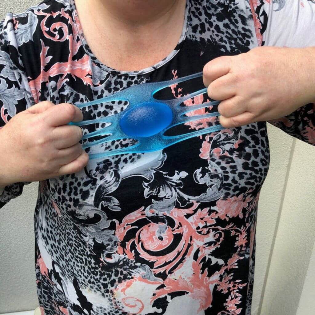 Picture of a woman stretching Out of This World Grip Emotional Regulation Strengthening tool