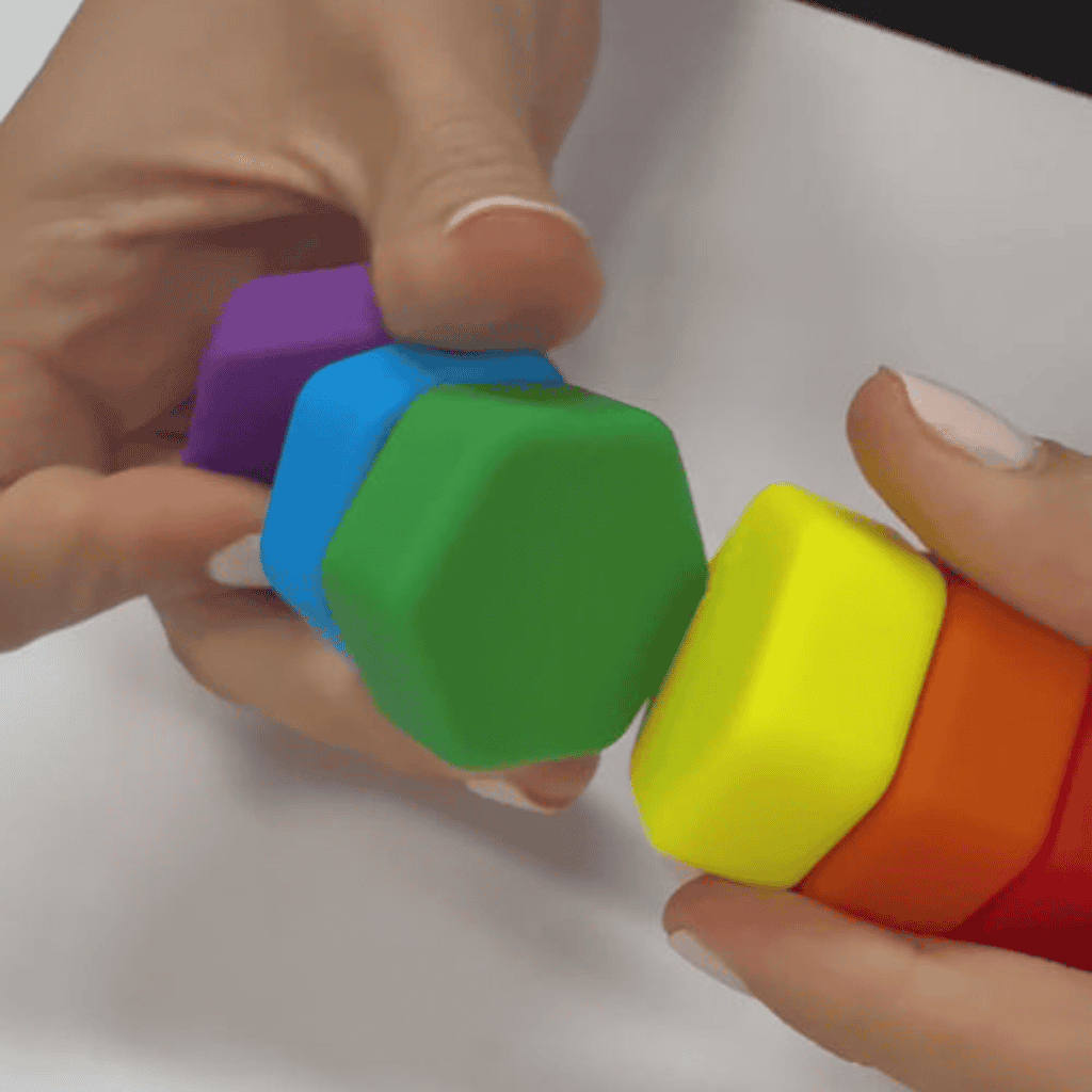Picture of hand playing with MagStak Hive Smooth
