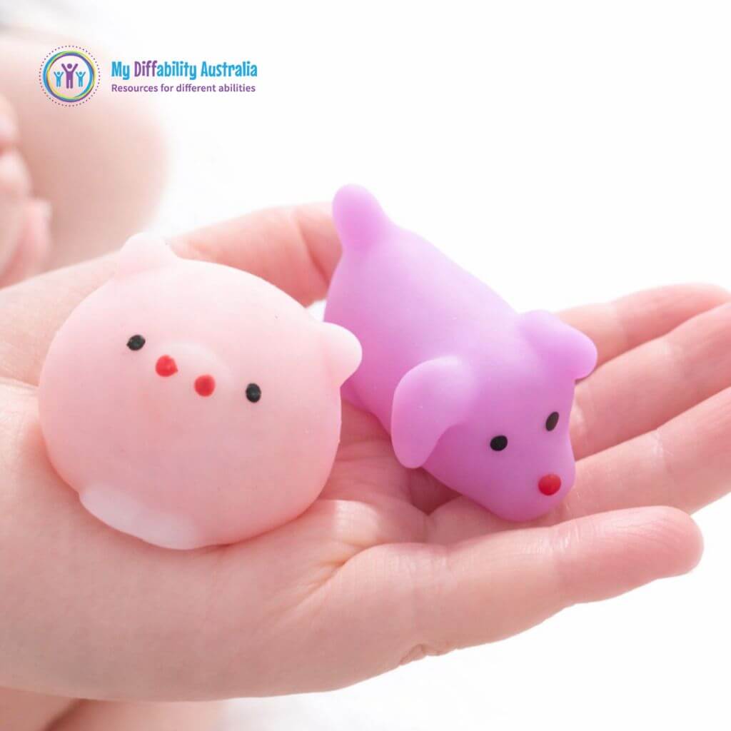 Pig and Dog Animal Squishie in a kids hand