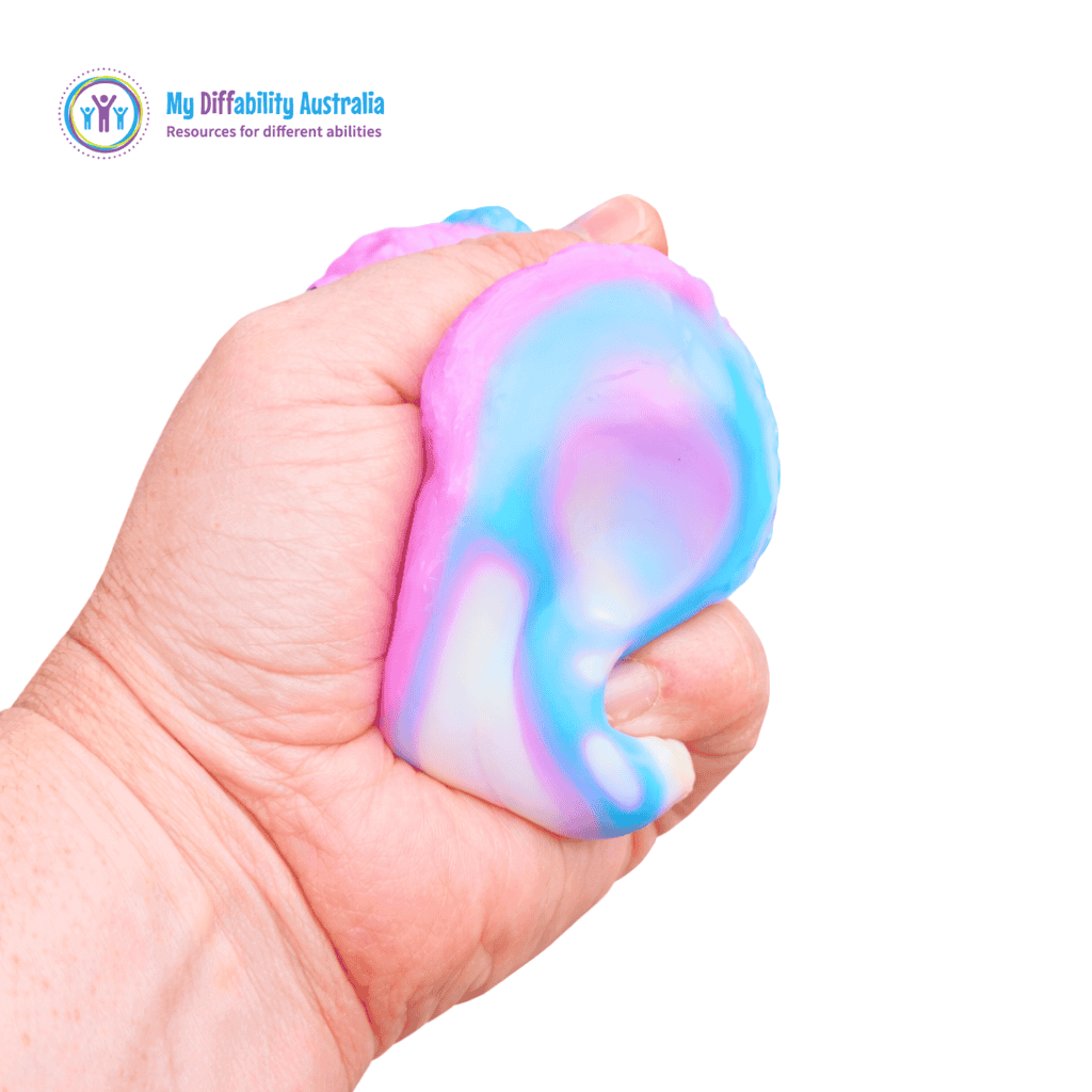 Side View of a hand squeezing Smooshmies Rainbow Sticky Bear