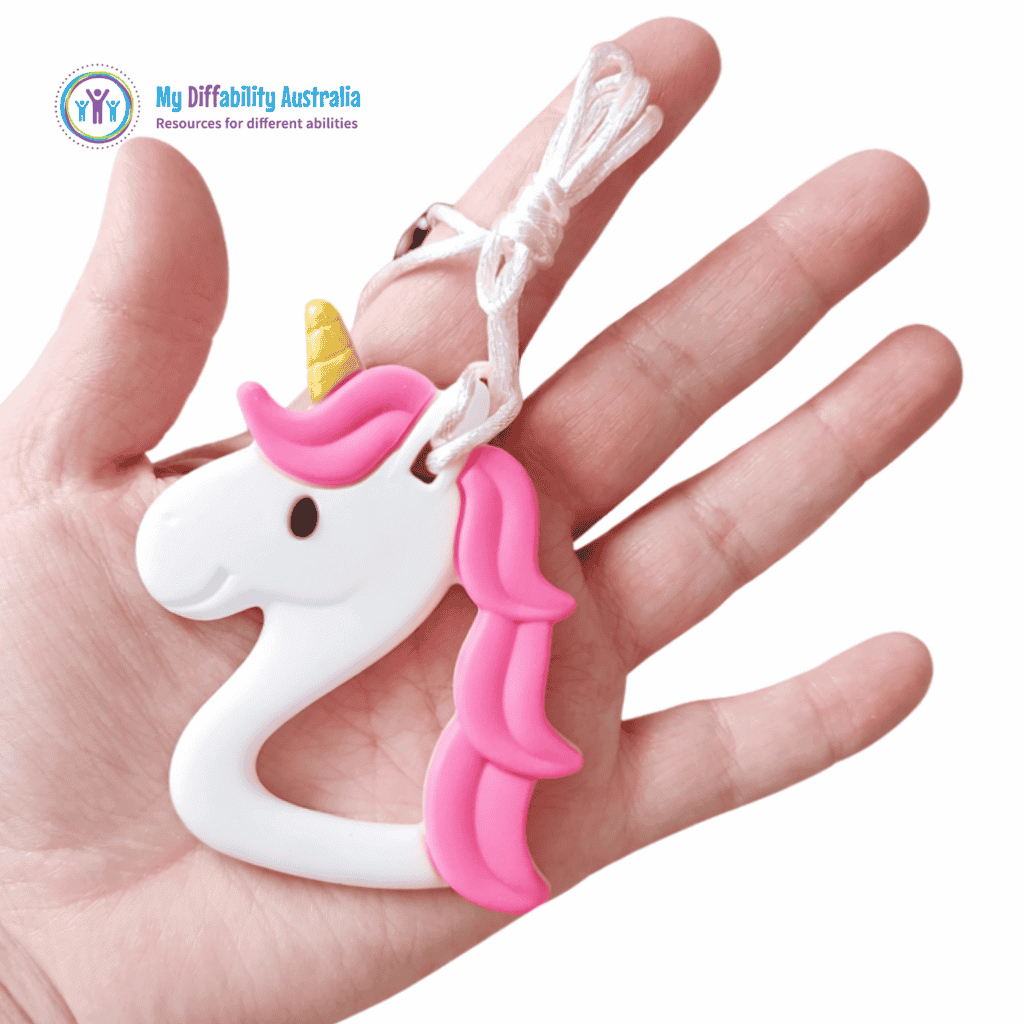 Unicorn Chew Necklace Placed in a hands palm