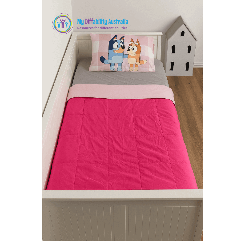 Vertical Full View of a bed wth weighted blank single pink on pink