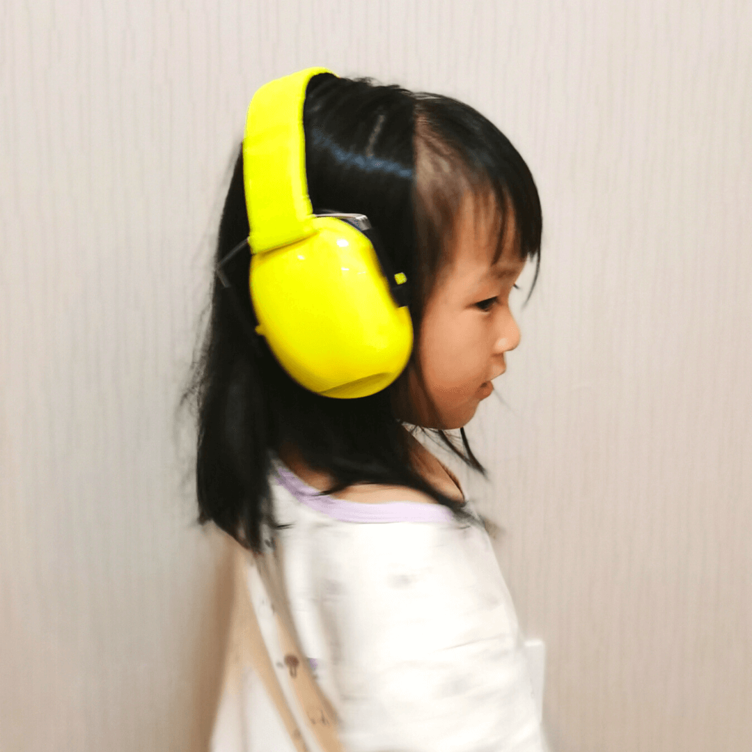 Yellow Ear Muffs Woen by Little Girl Facing Right