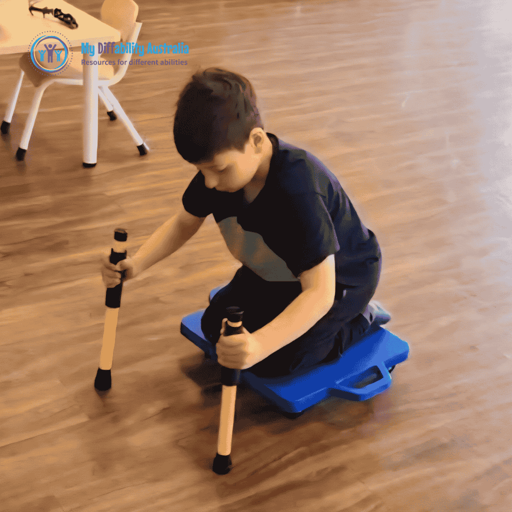Young Boy Holding 2 Scooter Paddles Yellow While Seating in the scooter board