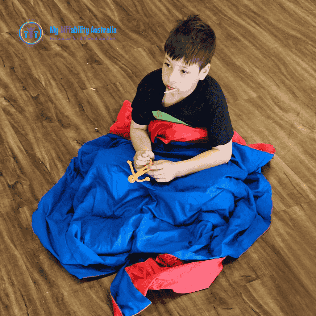 Young Boy Seating While Weighted Blanket Blue on Red is on his lap