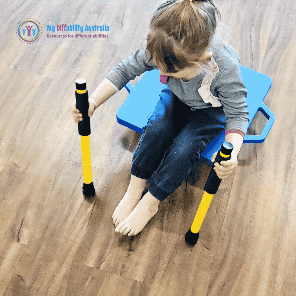Young Girl Holding 2 Scooter Paddles Yellow While Seating in the scooter board