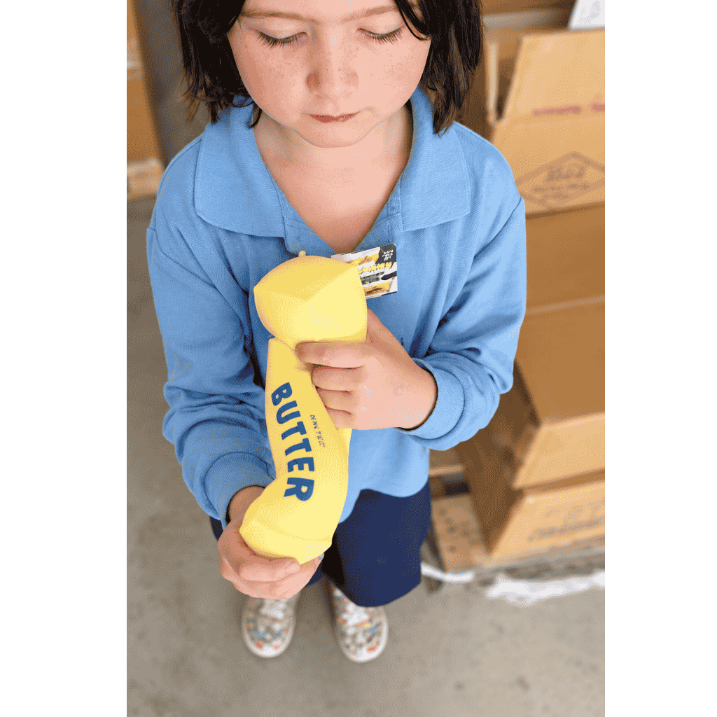 Young Girl Holding Giant Butter Squishy