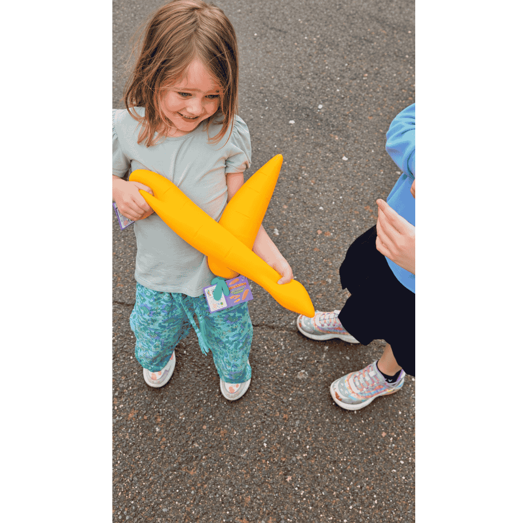 Young Girl Holding Giant Carrot Squishy