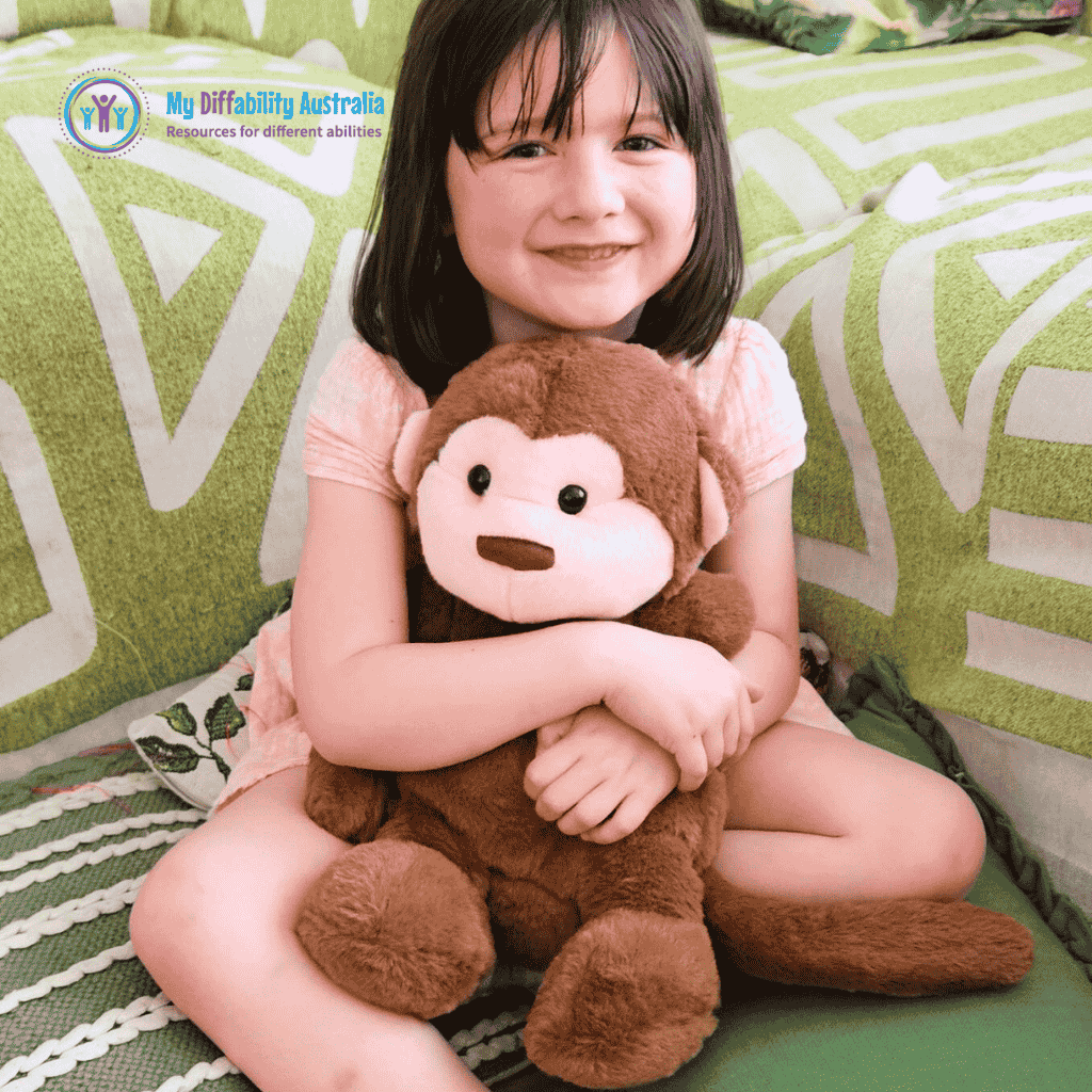 Young Girl Hugging Monkey Weighted Toy