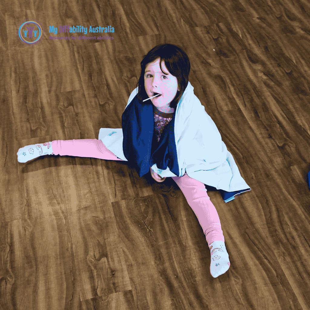Young Girl Looking in the Camera While On her Shoulder is the Weighted Blanket Blue