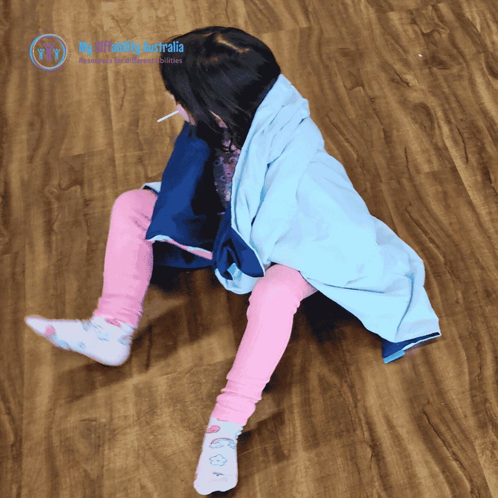 Young Girl Looking in the Side While On her Shoulder is the Weighted Blanket Blue
