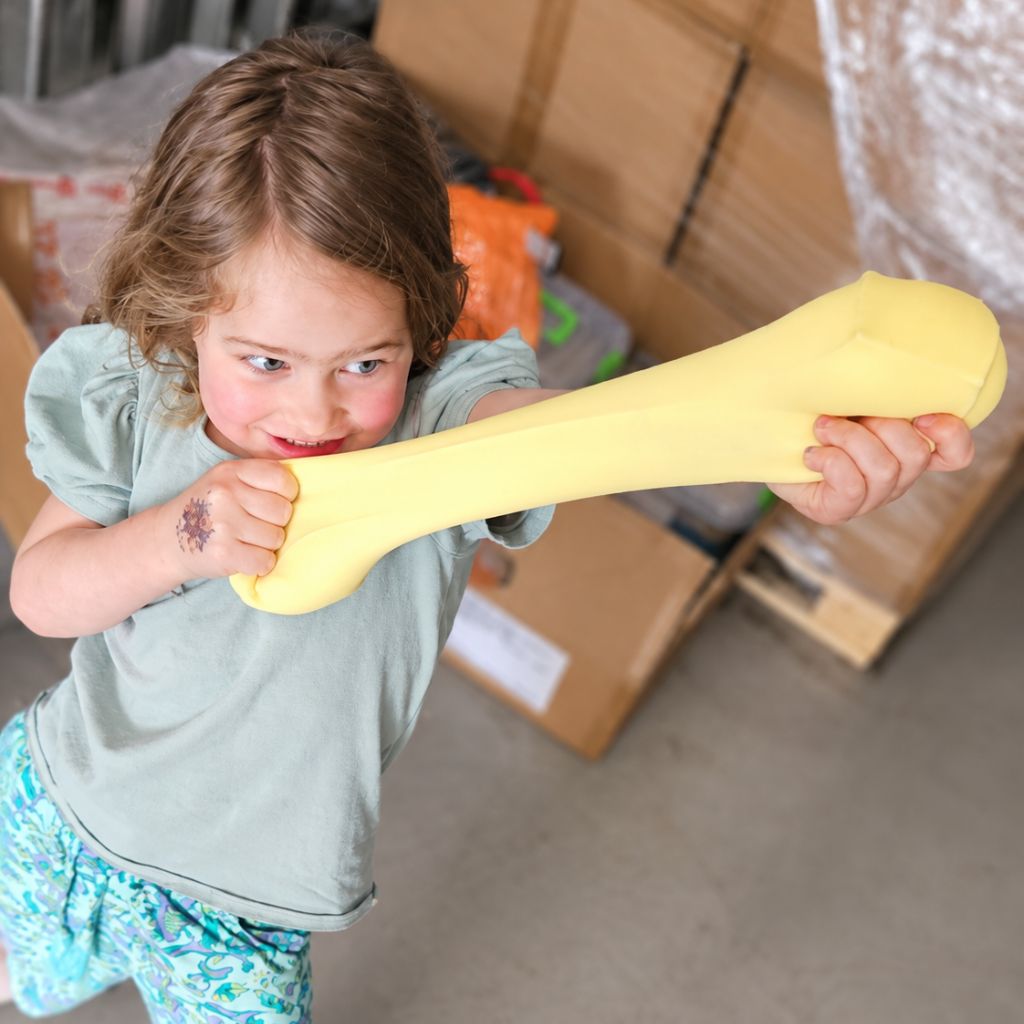 Young Girl Squishing Giant Squeeze Mega Mellow Butter Squishy