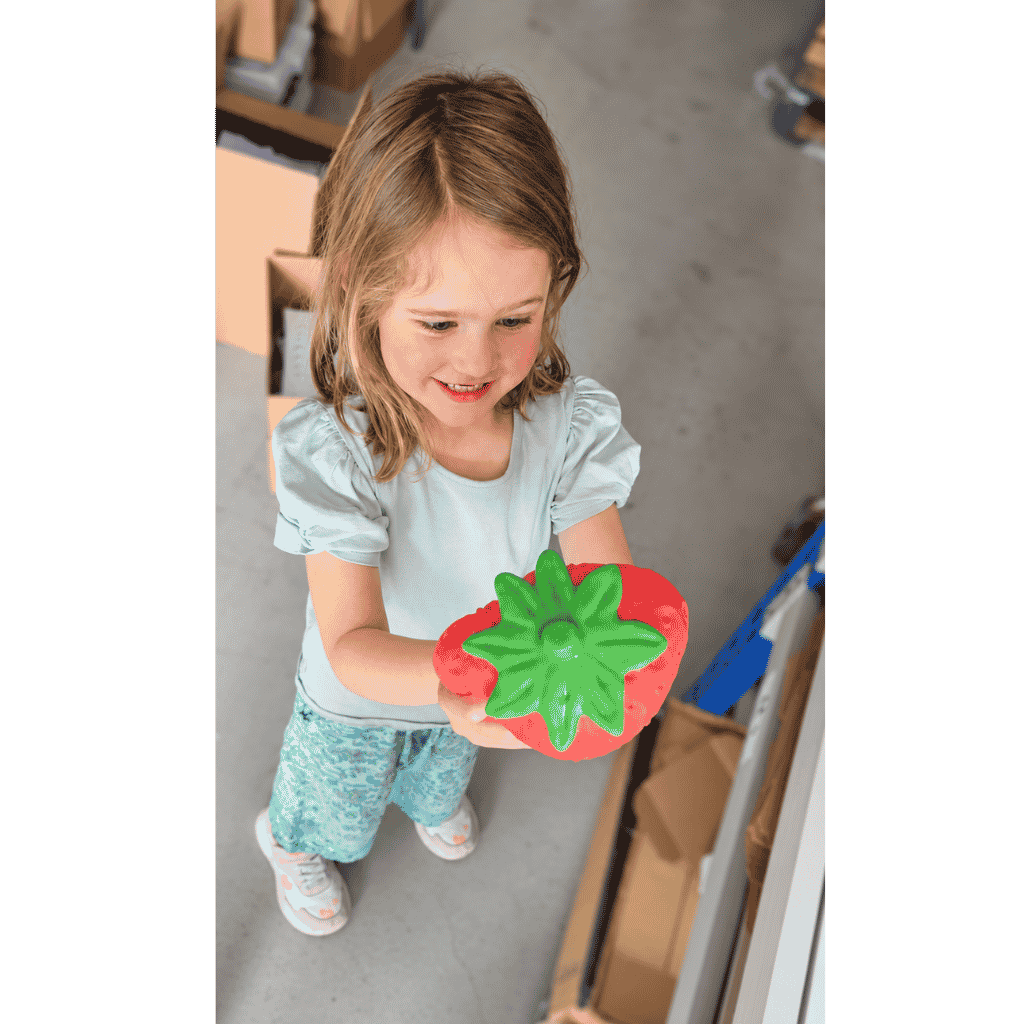 Young Girl Squishing Giant Strawberry Squishy