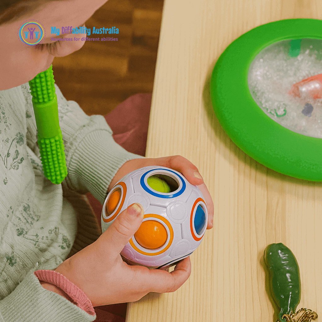 Young Girl Holding Magic Sphere Ball Puzzle While Chewing Textued Hollow Bite Green