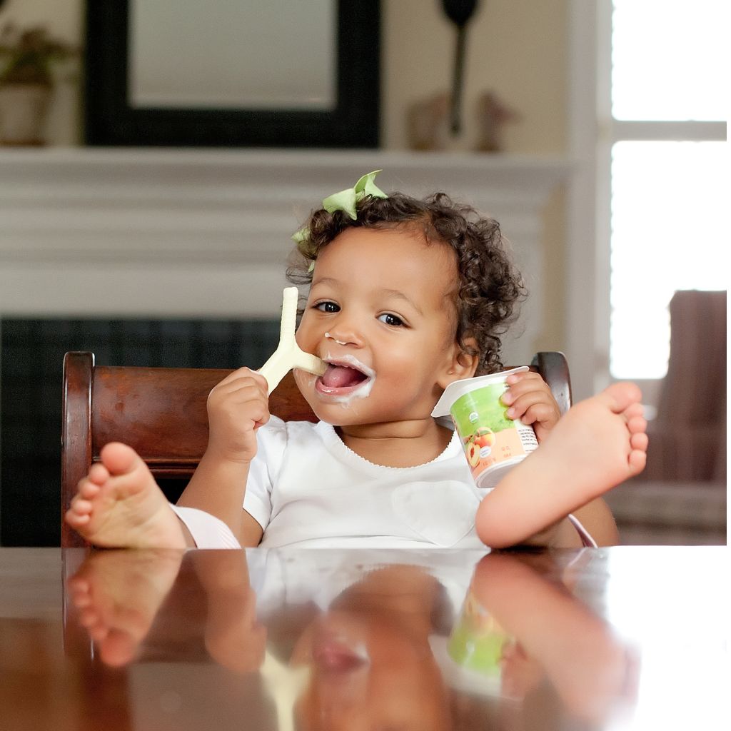 Young girl biting ark y handheld chew