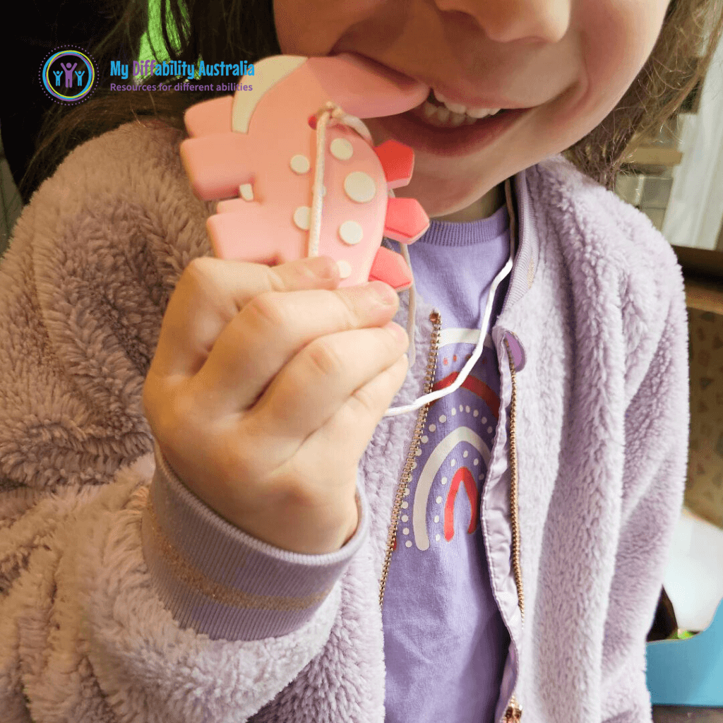 Zoom In Kid Biting Dinosaur Chewy Pendant