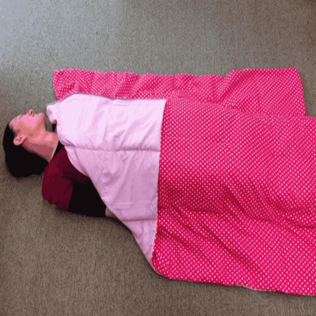 adult women lying in the floor using weighted blankets made to order