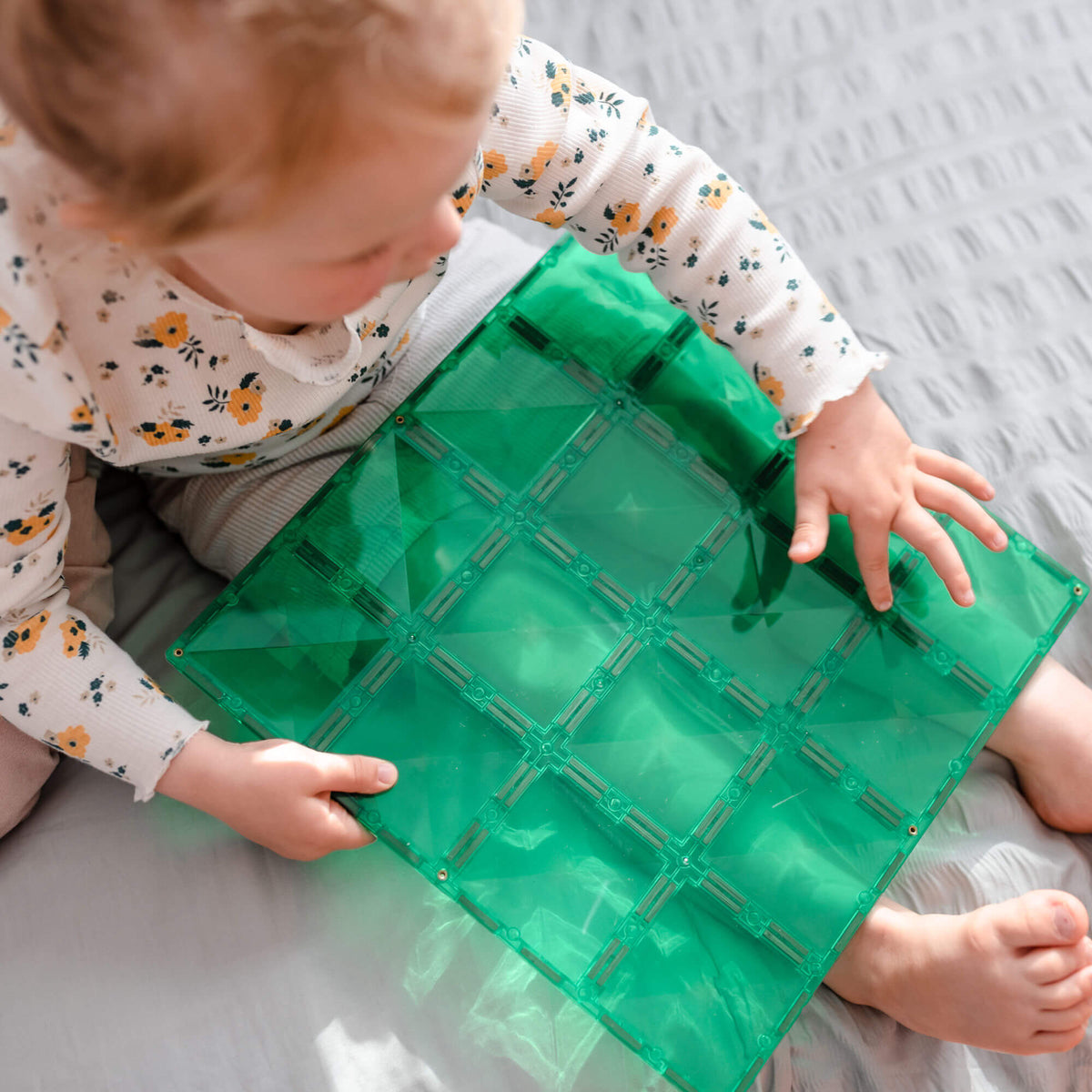 kid holding 2 piece base plate green