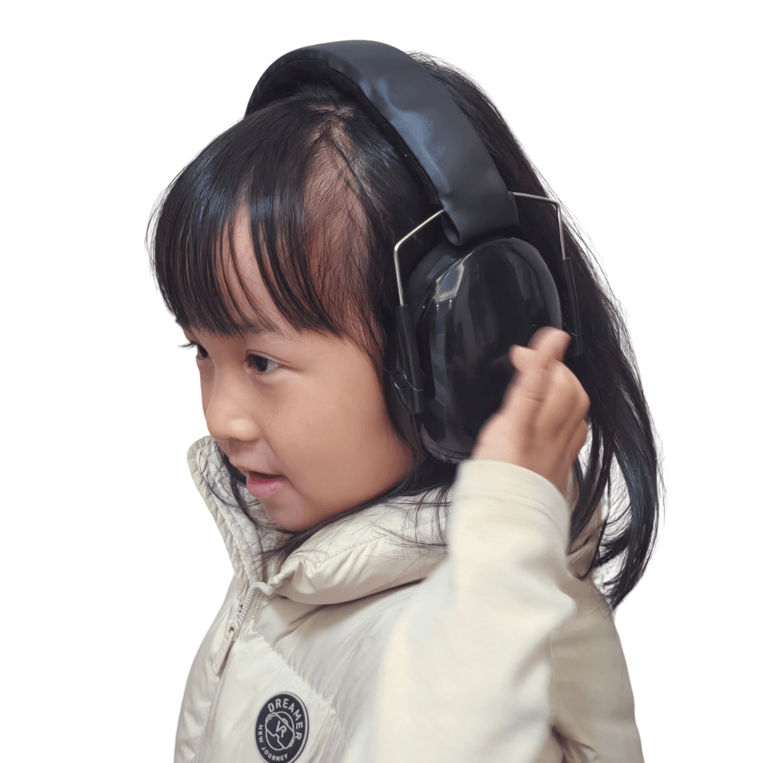 kid holding ear defender muffs