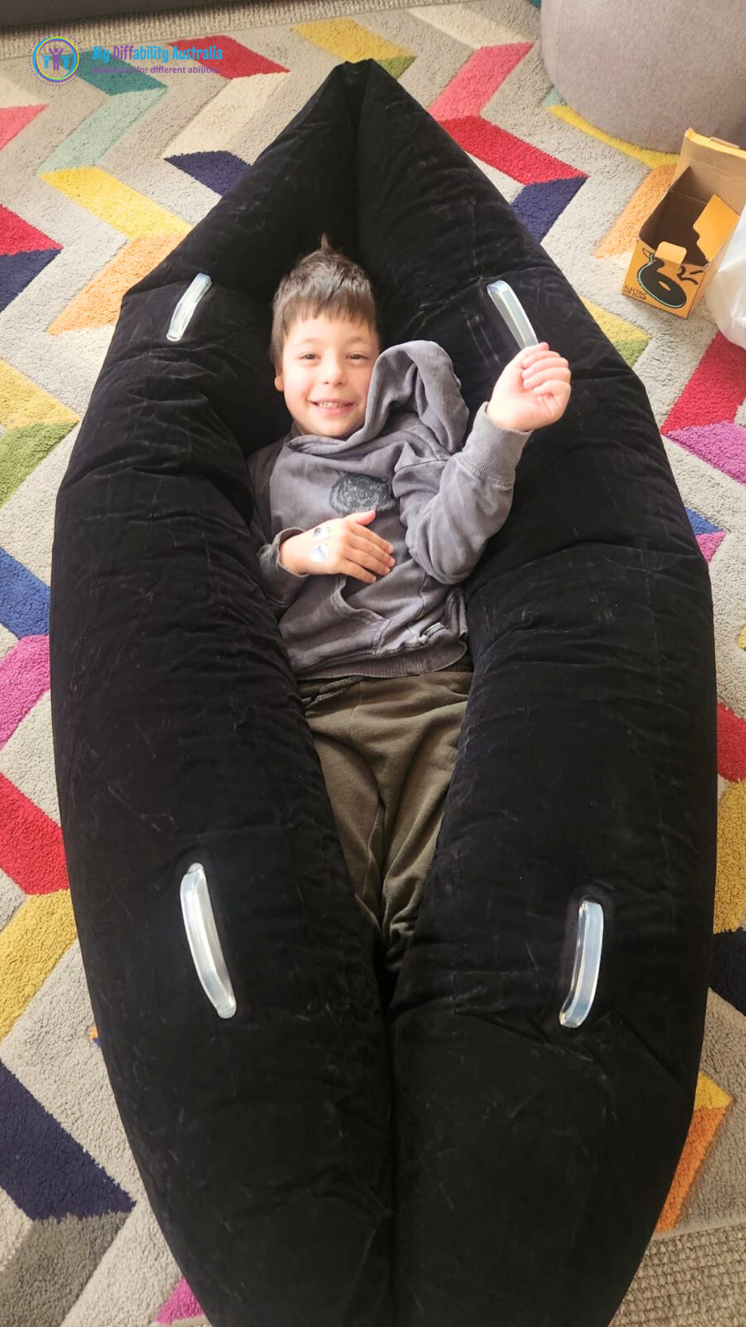 kid laying inside the sensory peapod