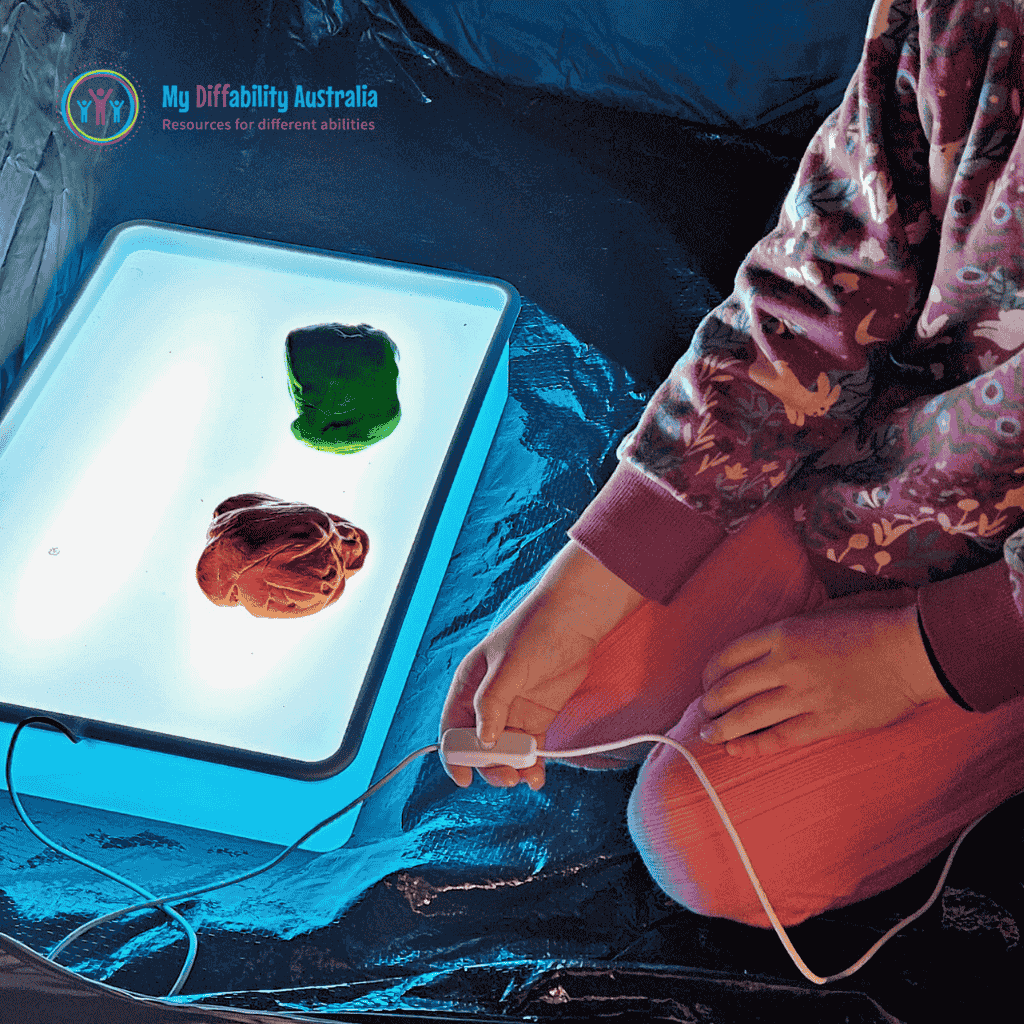 messy play light box inside a black tent